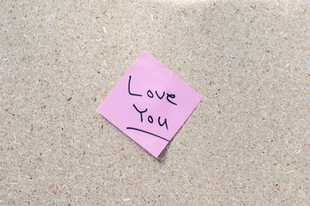Love you hand written note on a corkboard with copy space
