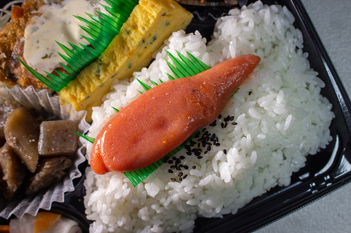 Closeup Karashi Mentaiko on a bento box. Mentaiko is the traditional Japanese food made by tarako (salted cod or pollack roe) with mixture of red pepper, dashi sauce, and other ingredients