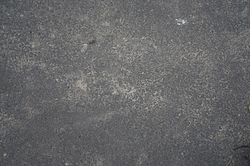 Surface grunge rough of asphalt, Seamless tarmac dark grey grainy road, Texture Background, Top view. Asphalt sprinkled with sand, asphalt texture. Selective focus