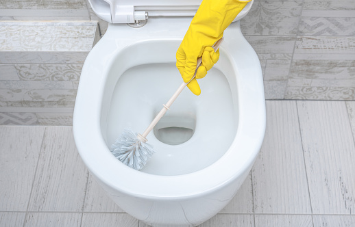 cleaning wc. Housekeeper, cleaning man at toilet. Brush up Toilet for cleanliness and hygiene. cleaning toilet bowl. Cleaning service concept