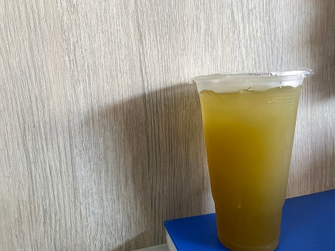 a glass of cold drink next to the wall