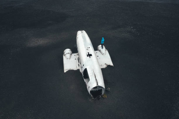 istock Man Standing On Abandoned Airplane Wreckage 1437178833