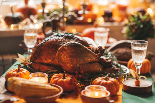 istock Thanksgiving holiday dinner table setting with fall decoration and pumpkins 1437179933