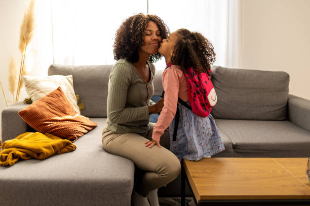 mother preparing her daughter for first day in school - first day of school imagens e fotografias de stock