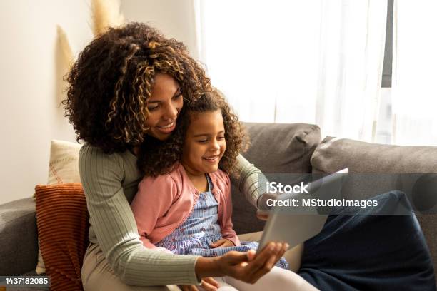 Mother And Daughter Using Digital Tablet Stock Photo - Download Image Now - Family, Digital Tablet, Child