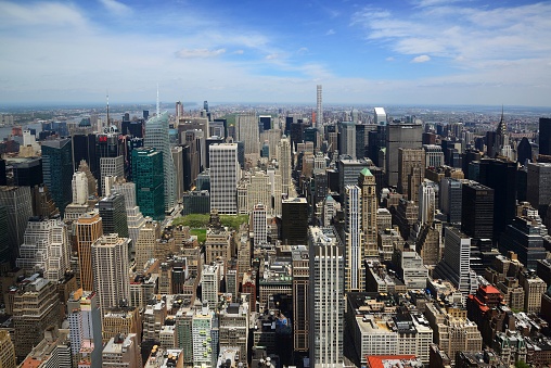 An aerial view of buildings with a blue sky in New York City