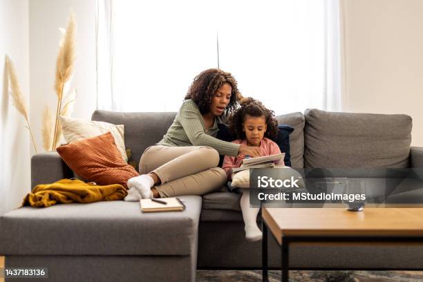 Mother And Daughter Doing Homework Together Stock Photo - Download Image Now - Child, Mother, Homework