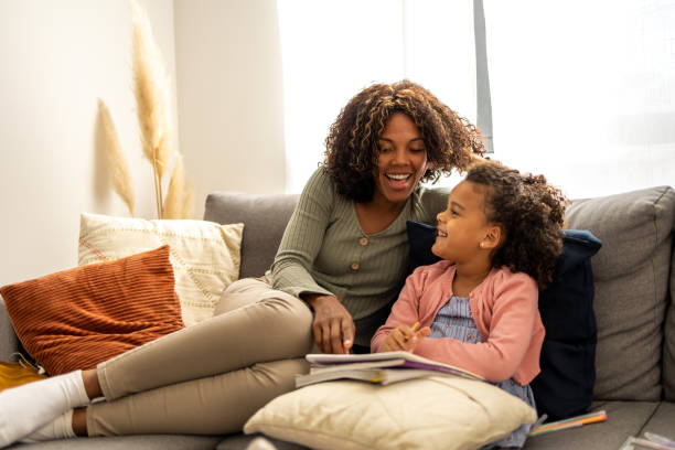 istock Mother helps daughter to study 1437183550