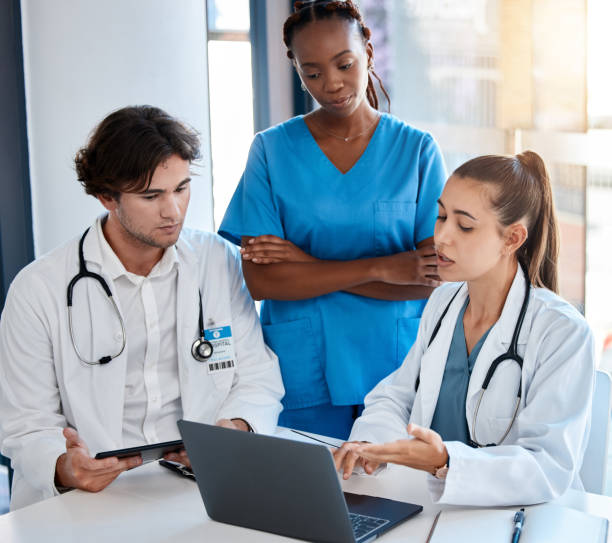 istock Teamwork, doctors and collaboration on laptop during a meeting in a conference room. Diverse healthcare workers discussing modern treatment and innovation, brainstorming to find a cure for sickness 1437187309