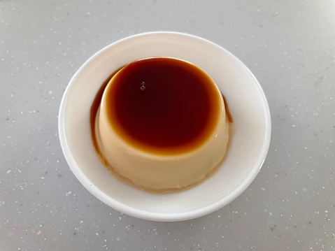 A small plate of Milk pudding with caramel sauce