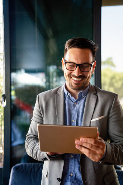 istock Portrait of young business man working on digital tablet 1437190549