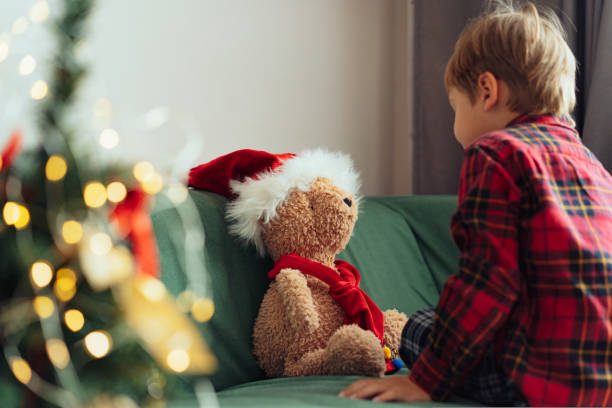 istock cute little boy dressing up teddy bear 1437190702
