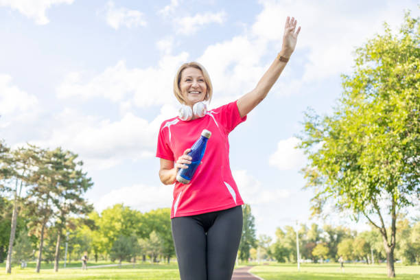 istock Woman greeting passengers when jogging outdoors 1437190719