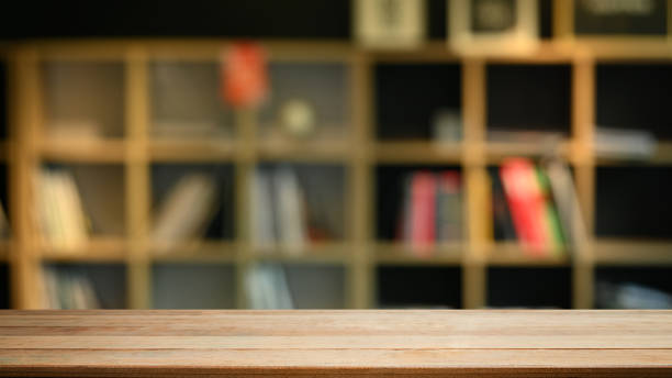 istock Empty wooden against blurred bookshelf background. Copy space for your product display or design montage. 1437192353