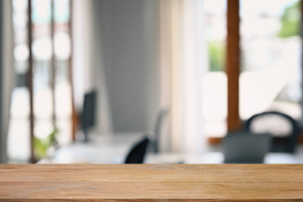 istock Wood table against blurred home office interior background. Copy space for your product display or design montage. 1437192355