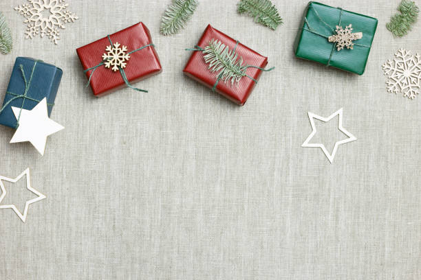 istock Christmas and New Year gift boxes, zero waste, eco friendly packaged gifts in kraft colored paper, green fir tree branches on table, preparation colorful xmas presents, eco christmas concept 1437192457