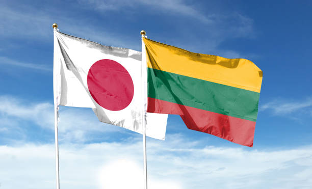 japanische und litauische flaggen am bewölkten himmel. winkt am himmel - libya flag libyan flag three dimensional shape stock-fotos und bilder