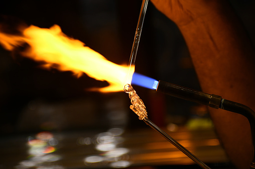 A closeup shot of a burning fire flame from the machine in the darkness