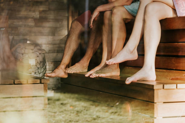 Friends taking time off at backyard Sauna stock photo