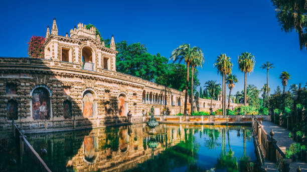 Beautiful amazing gardens in Royal Alcazar Sevilha, Spain – July 30, 2020: Beautiful amazing gardens in Royal Alcazar, Real Alcazar de Sevilla - residence developed from a former Moorish Palace in Andalusia, Spain ancient creativity andalusia architecture stock pictures, royalty-free photos & images