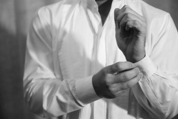 istock Man fastens a button on a classic shirt 1437197597