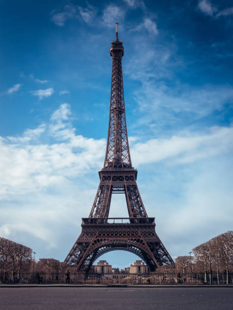 istock Beautiful vertical shot of the Eiffel Tower on a bright blue sky background 1437197664