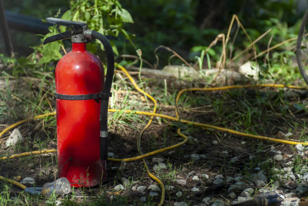 istock Closeup shot of a water extinguisher and firehose 1437199802
