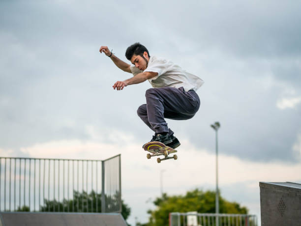 istock Young Caucasian man doing tricks with a skateboard at a skate park 1437201872