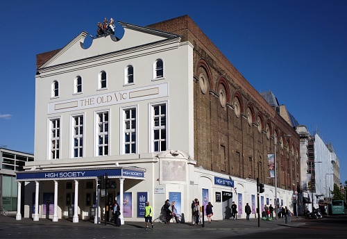 London, United Kingdom – May 12, 2015: The Old Vic Theatre, London, United Kingdom, showing people walking and standing near the theatre, on a sunny day with a blue sky.