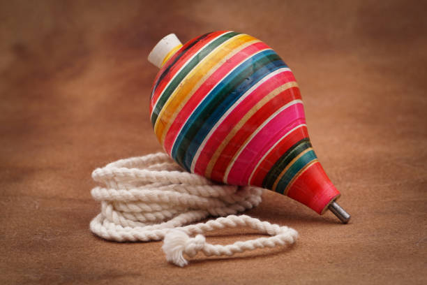 istock Colorful trompo on a brown background 1437203998