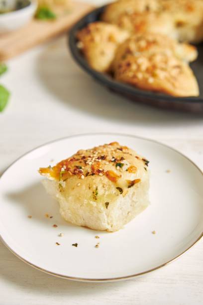 istock Freshly-made delicious cheese bubble pizza bread with ingredients and cheese on a white table 1437204286
