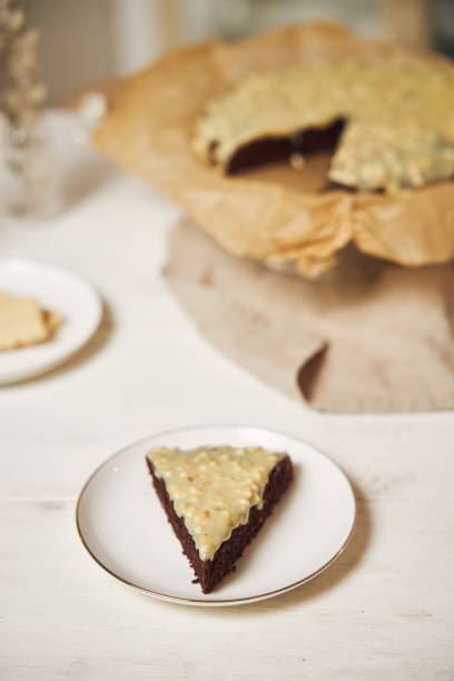 istock Delicious chocolate cake with cream on a white table presented with aesthetic details 1437204344