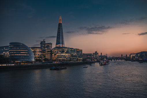 City of London landscape at sunset, looking towards the southbank from the London Brigde atop the Thamesis