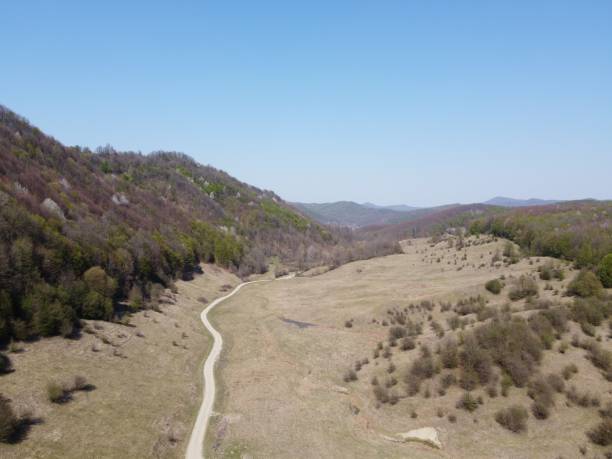 istock Long trail leading through colorful tree-covered hills 1437206572