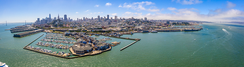 An aerial view at Sunrise of the china basin and Oracle Park as the sun comes up. Marina filled with boats in front of the Stadium.