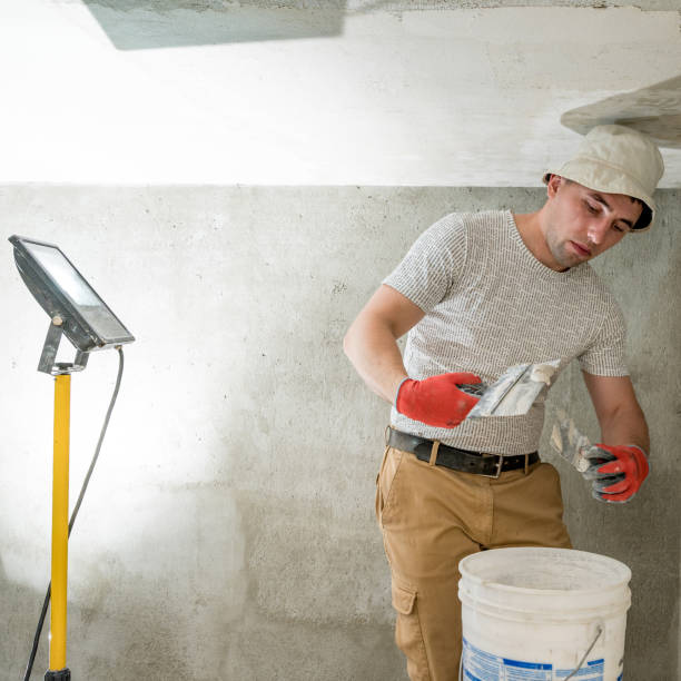 istock The master works with lime plaster, leveling the wall with a spatula and lime plaster. 1437208200
