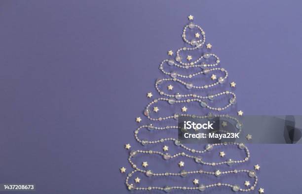 Glass Beads Laid Out In Shape Of Christmas Tree On Purple Background Stock Photo - Download Image Now