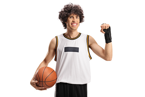 Basketball player wearing a wrist splint brace and smiling isolated on white background