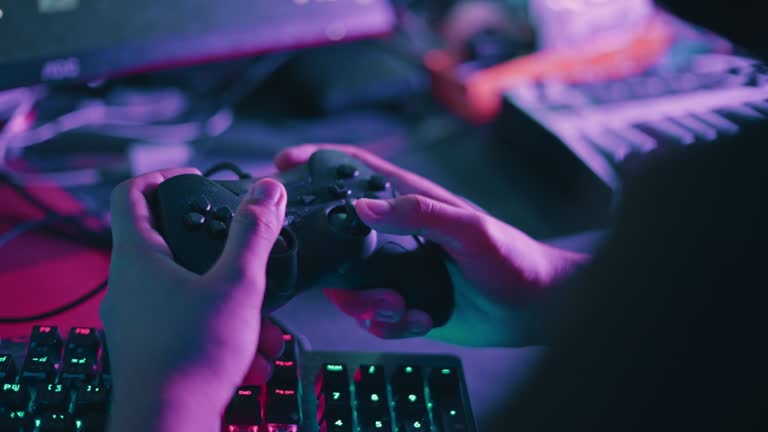 Boy using a controller while playing computer games