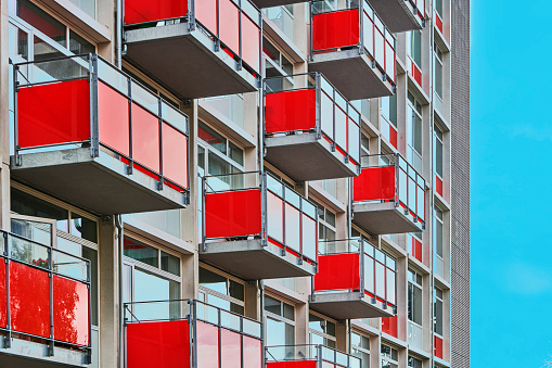 Residential building with new red balconies in development project on Nyborgvej in Odense