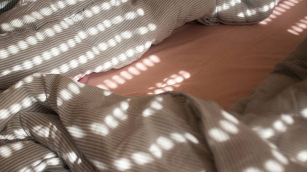 luci mattutine attraverso le persiane nel letto - bed messy empty sheet foto e immagini stock