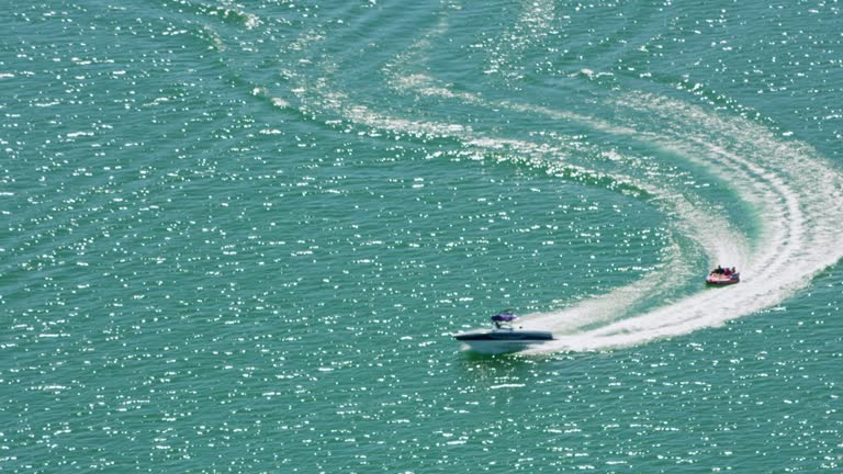 AERIAL People enjoying a boat ride on Lake Oroville, California