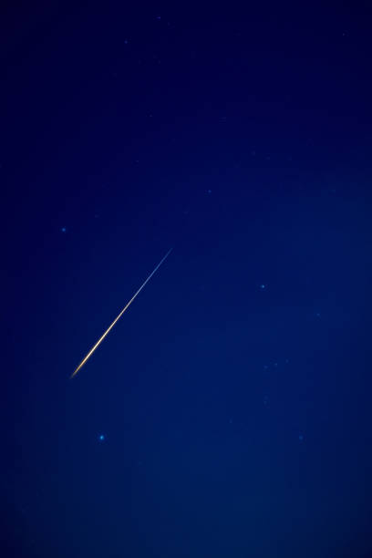 istock Stars, meteor trail on evening sky. 1437215730