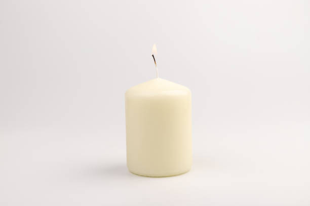 istock Burning white wax candles on white background. 1437216168