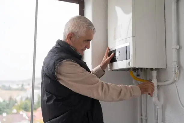 Photo of Senior Man Controlling The Boiler