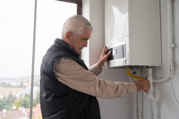 senior man controlling the boiler - radiator gas boiler residential structure house imagens e fotografias de stock