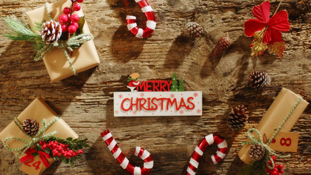 istock Merry Christmas text on wooden table background 1437216290