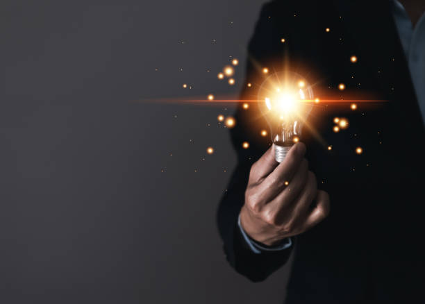 istock businessman holding a light bulb Digital technology. imagine an idea Creative and innovative. brain to brainstorm ideas in business. Strategies for development, growth, and success 1437218962
