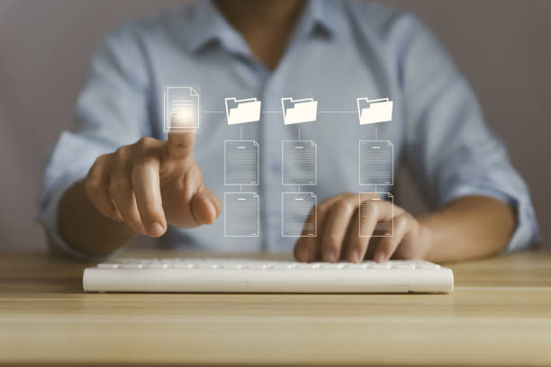 istock Businessman touch electronic document management on the virtual screen. Concept of effective access to the corporate online business database. internet technology Paperless office digital file system 1437219004