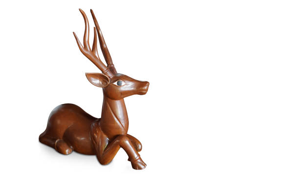 istock old long horned wood deer sleeping on white background, object, animal ,decor, gift, copy space 1437219080